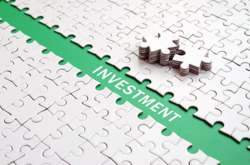 Investment. The green path is laid on the platform of a white fo The Money Game